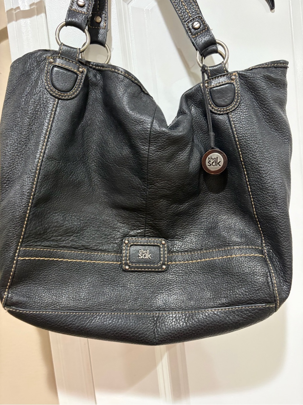The Sak Black Pebbled Leather Shoulder Bag with Brass Accents